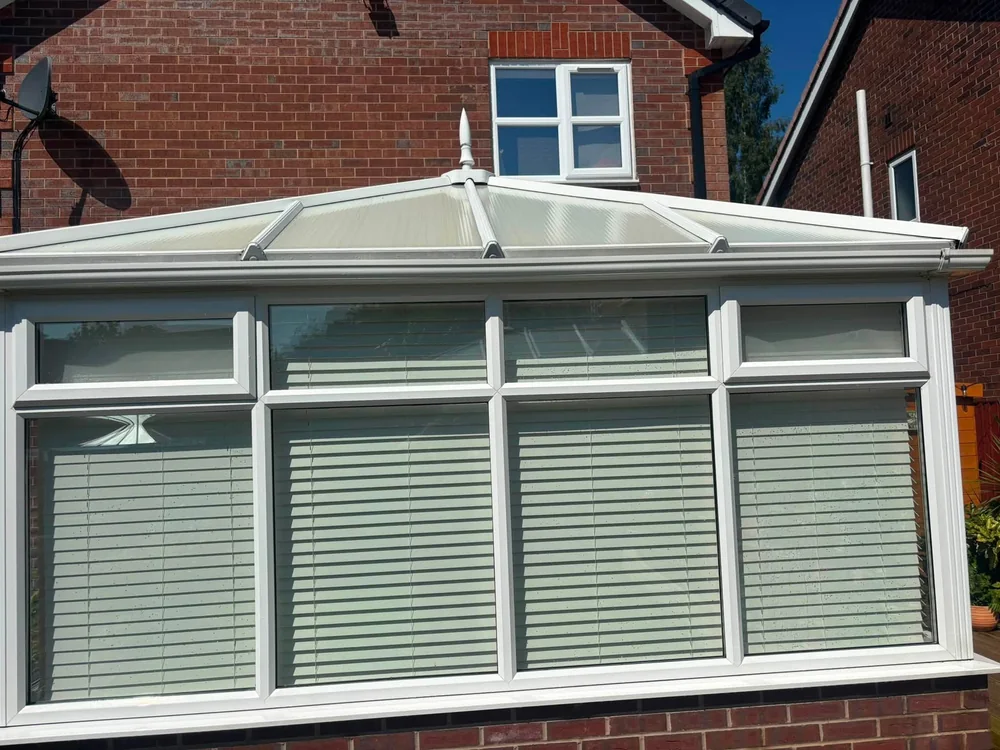 A finished conservatory with clean white frames and clear glass